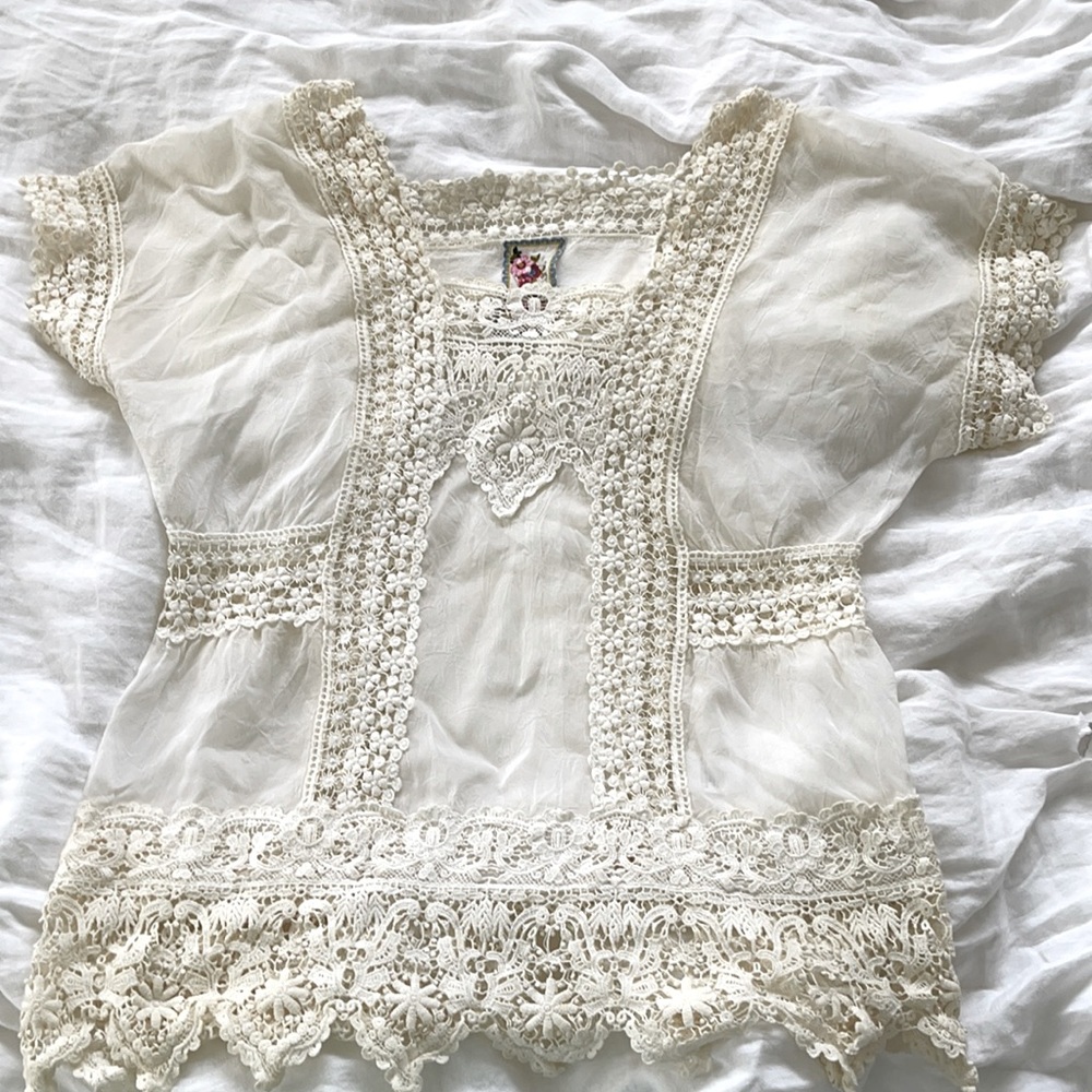 A white bathing suit crocheted silk cover up